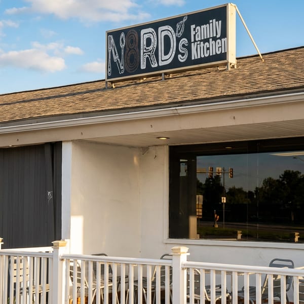 Exterior of N8RD's Family Kitchen restaurant with outdoor seating and a prominent sign.