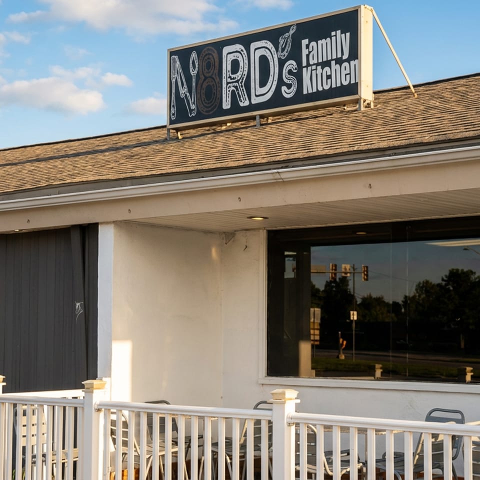 Exterior of N8RD's Family Kitchen restaurant with outdoor seating and a prominent sign.